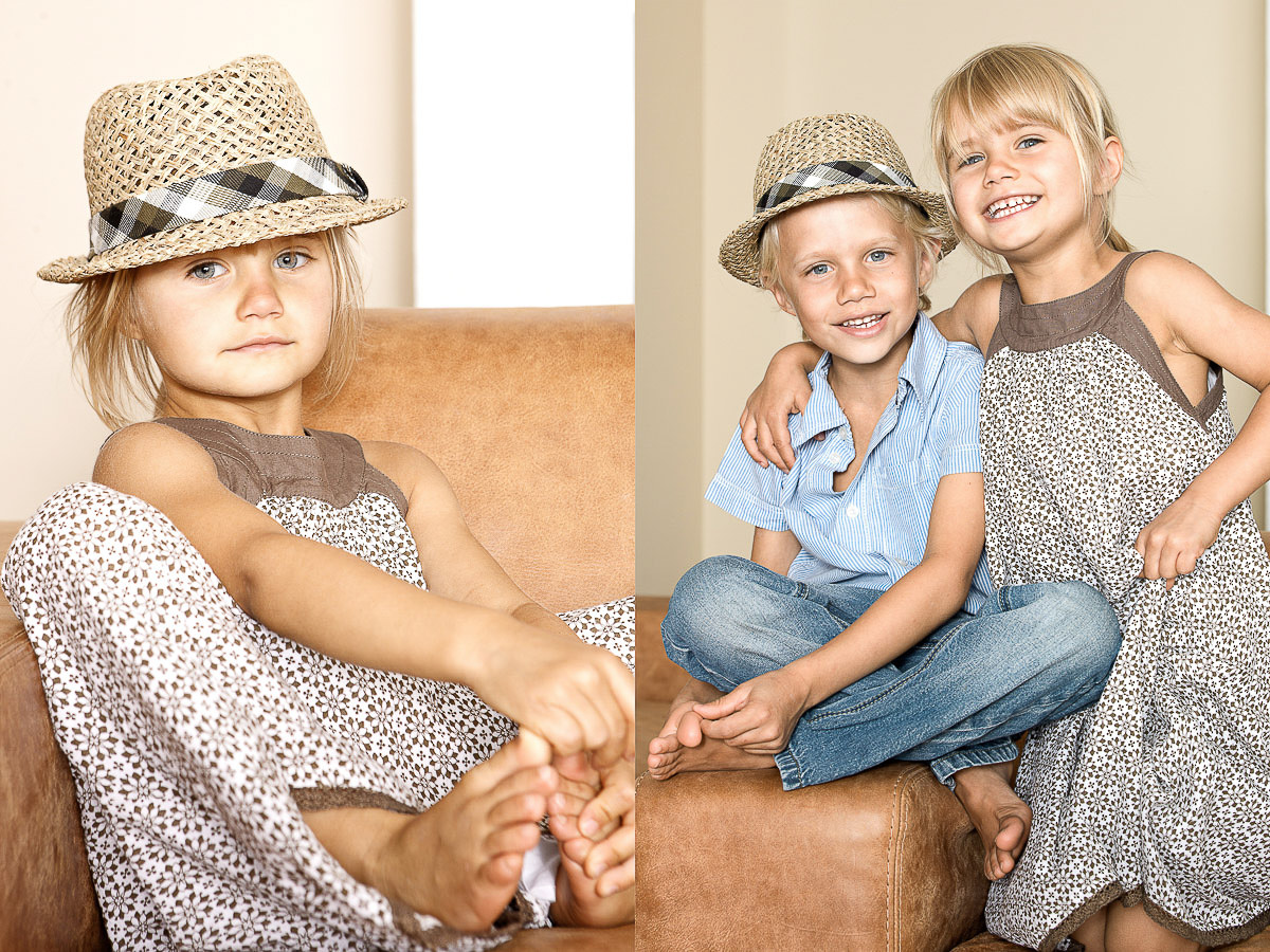 Zwei Kinder sitzen fröhlich auf einem Sofa und genießen ihre gemeinsame Zeit.